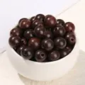 Natural dark brown sandalwood round beads for DIY jewelry making displayed in white bowl - Rosewood Round Bead