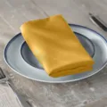 Golden satin napkin table cloth folded for hotel restaurant dining table and wedding decor elegant. - Gold