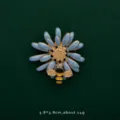 Detailed macro view of a blue enamel daisy brooch with a tiny golden bee accent - Bee with Sunflower