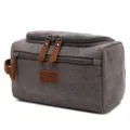 Close-up detail of gray canvas travel toiletry bag with brown leather zipper pulls - Gray