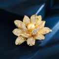 Elegant golden lotus flower brooch with micro-pave crystals and a central golden pearl - Gold Lotus Gold Pearl Center