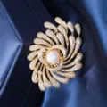 Close-up of luxury firework brooch with a center pearl and sparkling cubic zirconia. - Gold Firework White Pearl