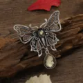 Vintage butterfly brooch with openwork design and dangling waterdrop gemstone - Champagne