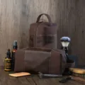 Vintage brown canvas and leather men's toiletry bag set in a grooming scene - Brown