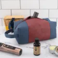 Vintage canvas and leather men's toiletry bag shown with grooming essentials on marble - Dark Blue