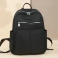 Minimalistischer schwarzer Oxford-Stoffrucksack für Damen mit silbernen Reißverschlüssen - Schwarz