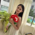 Handmade red and white crochet carnation flower bouquet held by model for gift display - Large Single Carnation (Red) / Single Stem Without Bag / Red