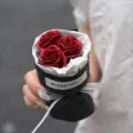 Mini artificial rose bouquet in black wrapping paper with gift ribbon for birthday decor. - Pocket Bouquet (Burgundy Rose)