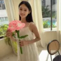 Handmade crochet carnation flower in pink and white held by woman in soft natural light - Large Single Carnation (Pink) / Single Stem Without Bag / Pink