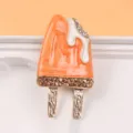 Close-up detail view of orange enamel popsicle brooch with rhinestone embellishments. - Melting Popsicle Style (Orange) / Orange