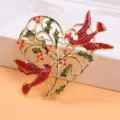 Macro view of golden heart brooch featuring red birds and green holly leaf details - Heart & Birds Shape (O5-1-5373)