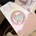 Close-up of a pink glitter heart-shaped magnetic phone grip with cute cartoon characters - Heart Magnetic Phone Stand / Single Stand / Sweet Pet Glitter Pink