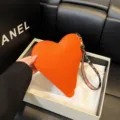 Bolso de mano de cuero naranja en forma de corazón con correa de muñeca estampada - Rojo Anaranjado