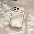 Detailed view of silver iPhone case featuring colorful star patterns and large camera cutout. - iPhone 17 Pro Max / Silver Gilded Stars
