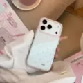 Close-up detail of a glittery transparent phone case with pink heart patterns and camera protection - Pink Lace Heart (Varnish) / 17promax / Clear