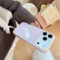 Gros plan d'une coque iPhone violette avec cadre de caméra jaune dans un cadre cosy - 17promax / Rose Baie Texte Cerise