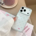 Close-up of a clear iPhone case with blue hearts and lace texture held by hand. - Blue Lace Heart (Varnish) / 17promax / Clear