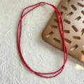 Vista dettagliata di una collana di perle di spinello rosso sfaccettato a strati - Diametro Perla 3,7mm / Rosso