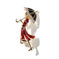 Close-up detail of a gold-plated enamel brooch featuring a girl in a red dress with an umbrella - Umbrella Lady in Red