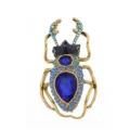 Detailed view of vintage gold beetle brooch with blue rhinestones and large crystal. - Blue