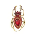 Detailed macro view of a punk style stag beetle brooch featuring vibrant red rhinestones - Red