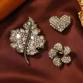 Elegant vintage 3-piece crystal brooch set featuring heart, leaf, and flower designs. - Maple Leaf Heart Brooch Set (10)