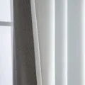 Macro detail of light grey velvet blackout curtain showing soft texture and quality - Grayish White