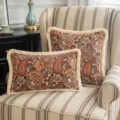 Vintage ethnic style paisley cushion covers with elegant fringe tassels on armchair - Cashew
