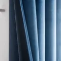 Close-up of premium sky blue and dark blue velvet blackout curtains with hook top - Aqua Blue