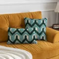 Bohemian tufted cushion covers with green chevron pattern displayed on mustard sofa - Green Herringbone