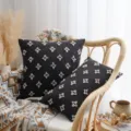 Nordic style black cotton throw pillow cover with white tufted star pattern on rattan chair - Black