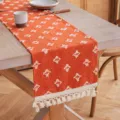 Camino de mesa de algodón naranja con patrones de estrellas tejidas y borlas decorativas - Caramelo