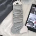 Light grey stirrup leg warmers with sweet lettuce edge trim and slouchy fit design - One Size / Light Gray