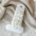 White knitted leg warmers with cable knit texture and ruffle edge, cozy winter fashion accessory. - One Size / White