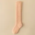 Soft and thick coral fleece knee-high fuzzy house socks in a delicate peach pink color - One Size (36-43) / Orange