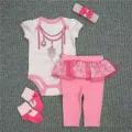 Detail of pink 4-piece reborn baby doll outfit for 55cm dolls on a textured rug. - Pink Jewelry Romper Set / For 55cm Dolls
