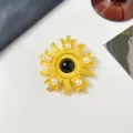 Macro detail of a vintage relief brooch with central black glass and elegant faux pearls - Sun Flower Medal Style / Black
