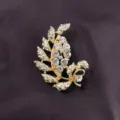 Close-up of a vintage Baroque gold-toned leaf brooch with sparkling clear rhinestones. - Leaf Style (B1)