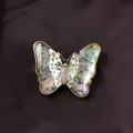 Close-up of vintage Baroque butterfly brooch featuring iridescent shell wings and gold trim - Shell Butterfly (B7)