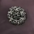 Close-up of vintage baroque brooch with sparkling black rhinestones on dark fabric - Radiant Petal (B3)