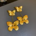 Macro view of vintage gold-finished butterfly double drop earrings with matte texture - 43# Silver Needle Earrings - Gold Color (Butterfly)