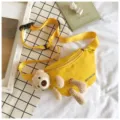 Detail view of yellow canvas waist bag featuring a cute 3D plush teddy bear design. - Yellow