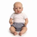 Detailed view of 22-inch realistic reborn baby doll in white tee and checkered pants - Blue Plaid Shorts Style / Cloth Body