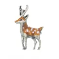 Detailed macro view of a vintage enamel sika deer brooch with white spots and silver antlers. - Deer