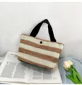 Close-up detail of a stylish brown and white striped straw woven handbag with black handles - 30*18*12cm / Khaki