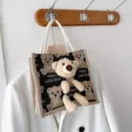 Detail view of linen tote bag with 3D plush teddy bear and printed design - 20x20x12 / Black