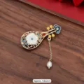 Detailed view of a vintage Chinese Pipa brooch with enamel work and a pearl drop - 351# Holding the Pipa