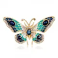 Close-up of vintage crystal butterfly brooch with blue and green enamel detail. - Style 14