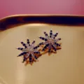 Vintage Baroque starburst earrings with navy blue and clear crystals on a gold tray. - Starburst Blue White Rhinestone Style (E7)