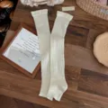 Cream white ribbed stirrup leg warmers featuring elegant vertical stripe knitting for winter - One Size / White